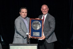 Dorman presenting his former supervisor at Penn, Mike Mahoney, with the ECAC-SIDA’s Irving T. Marsh Award in 2017.